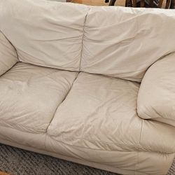Two beige Leather Love Seat