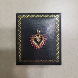 10 K Gold Rubies and Diamond Pendant.  Weight is 1.7 grams.  SALE Pending 