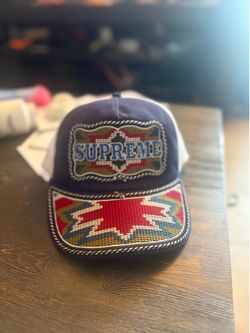 The Supreme Western Embroidered Mesh Trucker Hat is a stylish and versatile accessory for men, perfect for casual occasions during the summer and spri