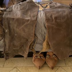 Antique cowboy leather batwing chaps with fringe and embossed logo