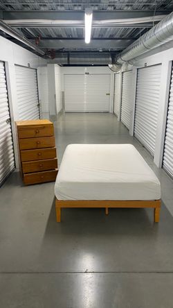 Full size bed frame with mattress and dresser