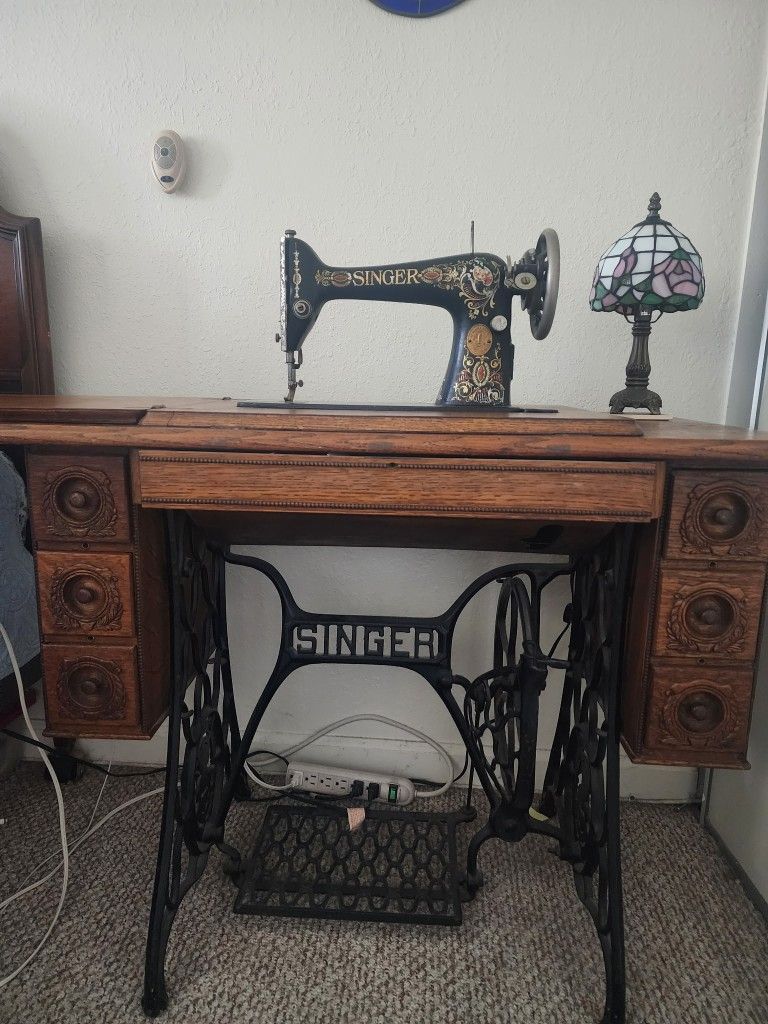 Antique Singer sewing machine in cabinet