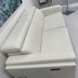 White Real Leather/Vinyl Power Reclining Sofa Loveseat Excellent Condition. Adjustable Headrest / Footrest. Dimensions: 83W x 33H x 43.5L. Was $2,400
