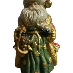 Santa Claus ceramic figurine.  The figurine is approximately 6 inches tall. It depicts Santa Claus with two puppies. The figurine appears to be hand-p
