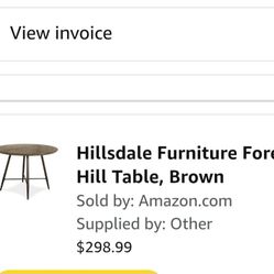 Selling by round table and four chairs.