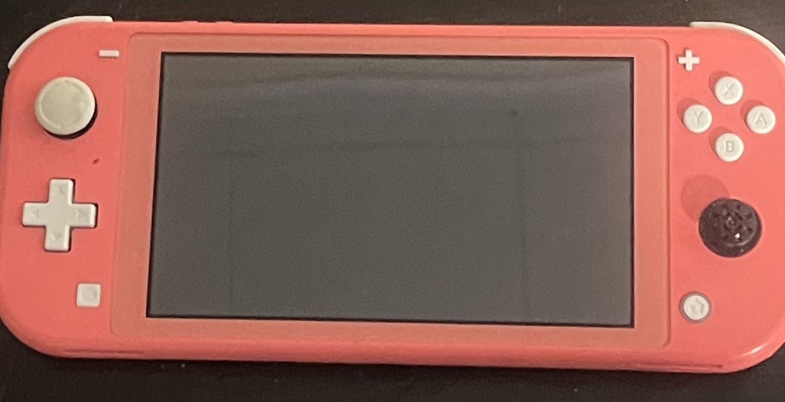 Pink Nintendo Switch Lite (missing joystick cover)