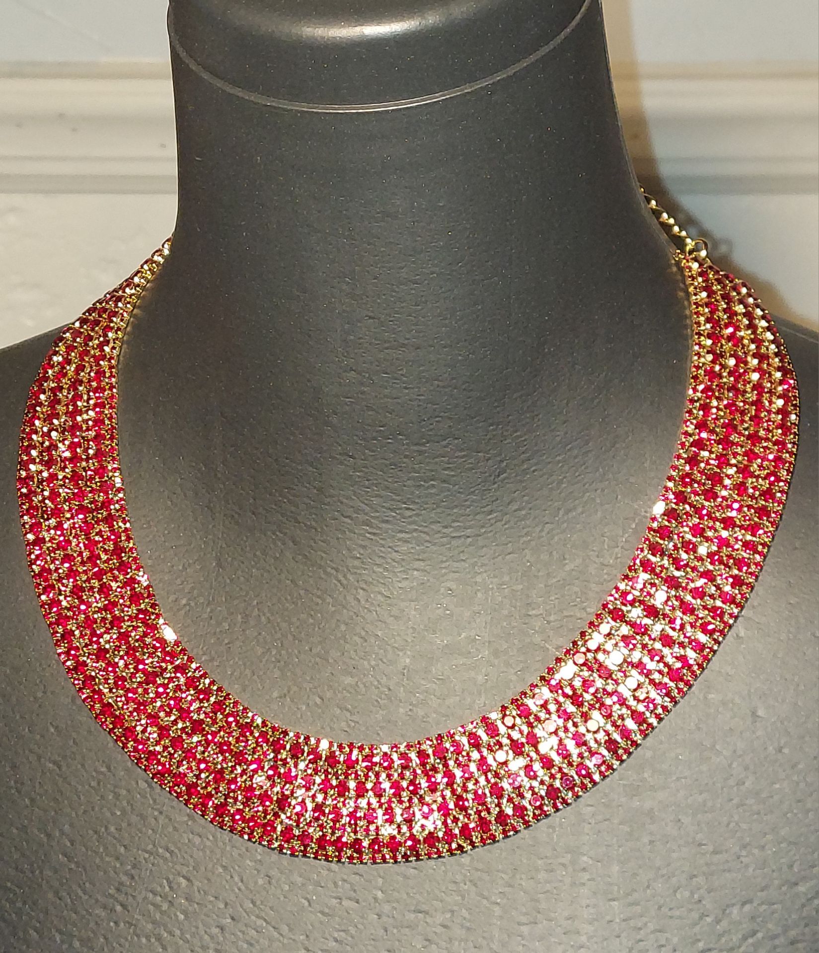 Natasha Couture red rhinestone crystal statement necklace features a multi-row design.
