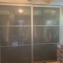 Large closet cabinet with Class sliding doors 9 foot wide 7’9” tall and 23 inches deep comes with the shelving and drawers