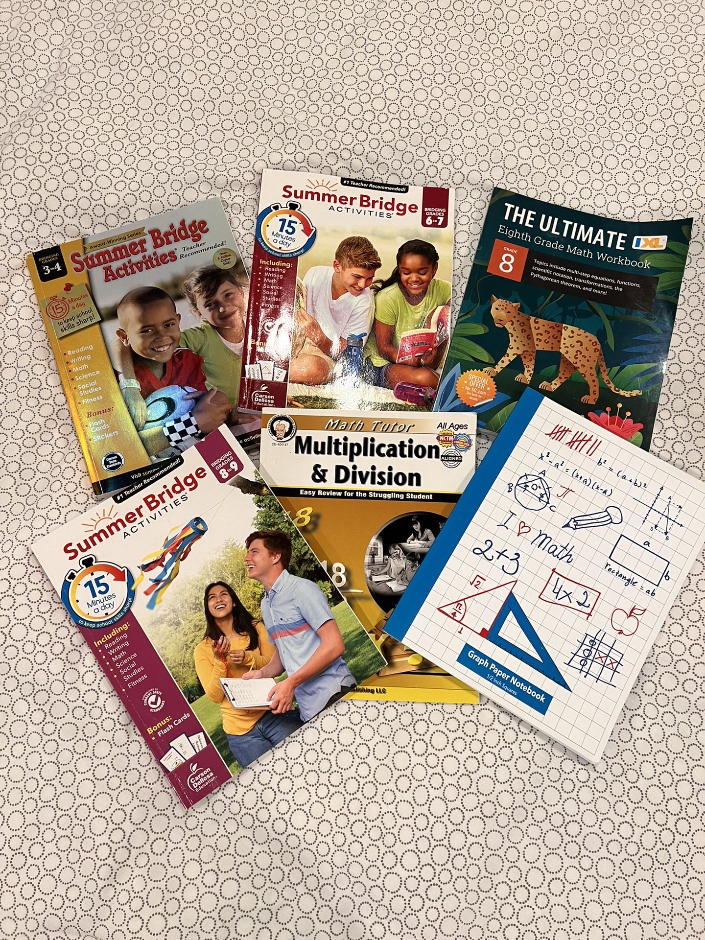 Collection of educational workbooks (5) and a notebook, primarily focused on summer learning and math skills