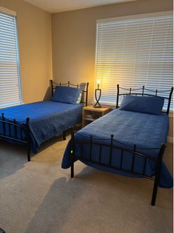 Twin black frame beds