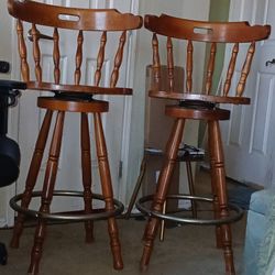 two Colonial swivel bar stools