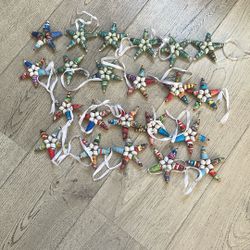  handcrafted recycled paper bead and papier-mâché star ornament made by artisans in Haiti
