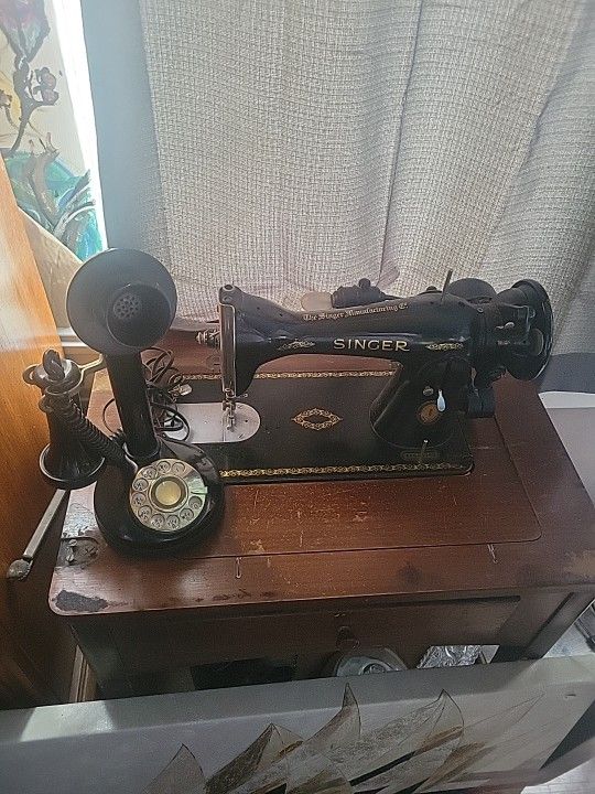 Antique Singer sewing machine paired with a classic rotary phone.