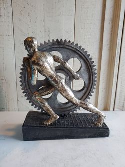 Man Pushing Gear Wheel Sculpture