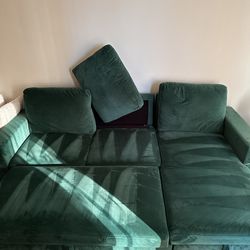 Green modular couch. It pulls out into a bed.
