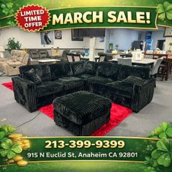 Black jumbo corduroy sectional sofa with ottoman