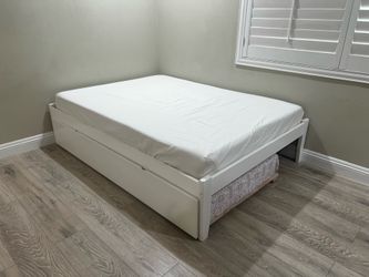Bed frame with unused mattress