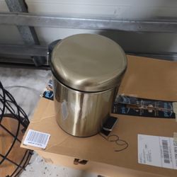 Gold lamp and trash can