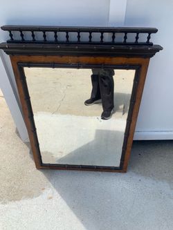 A late 19th-century faux bamboo wood wall mirror.