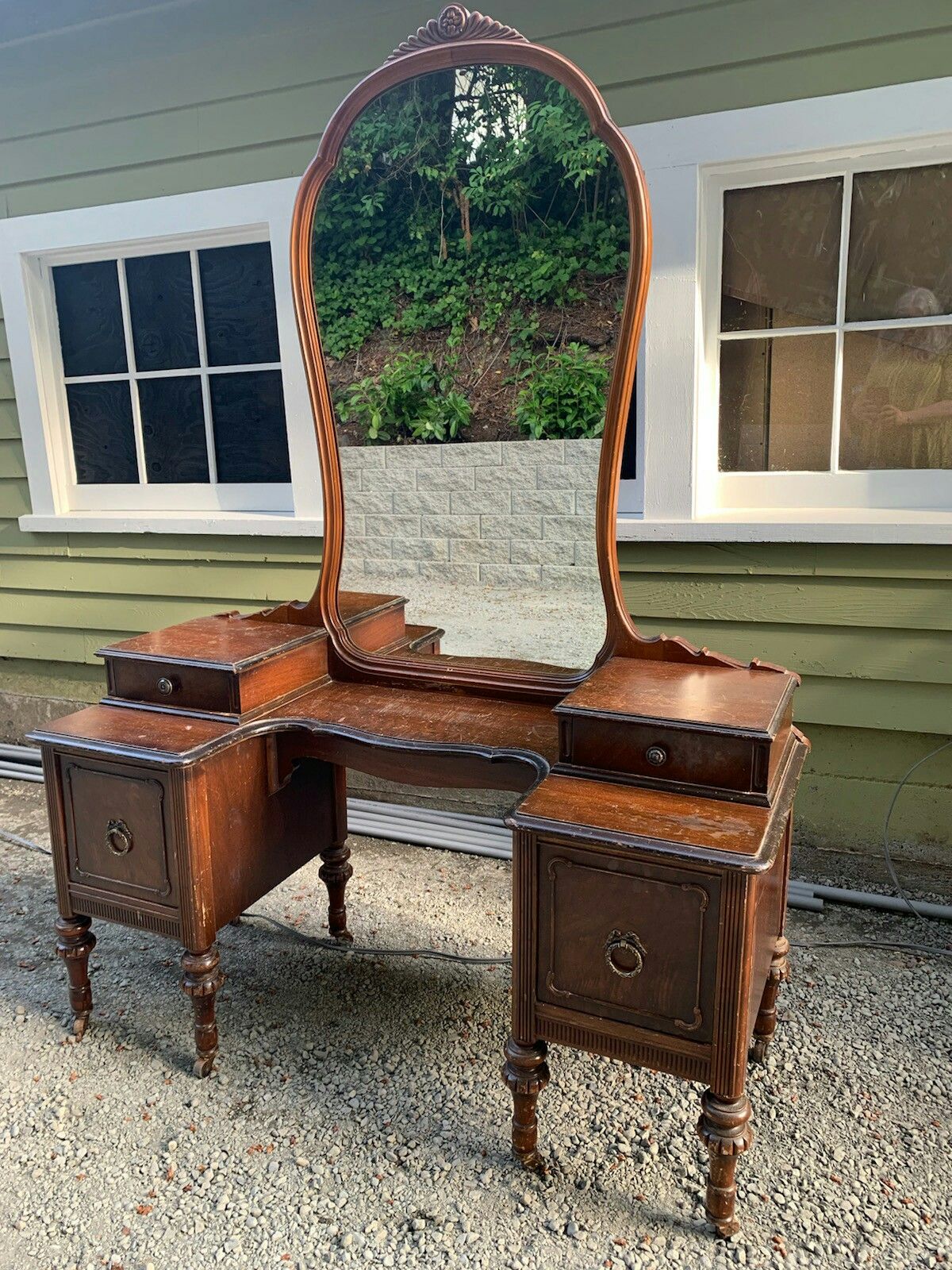 Old vintage or antique dresser / vanity / desk / drawers with stylish woodwork carving and patina brass / metal handles