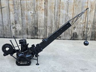 Metal wrecking ball crane sculpture
