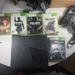 Xbox 360 with 5 games, 2 controllers, and charging cable