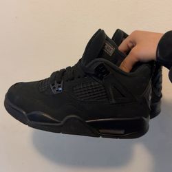 Black cat Jordan 4s