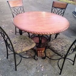 Table and chairs with bakers rack