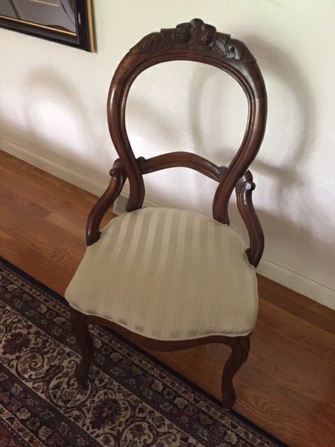 Six walnut Queen Anne antique dining room chairs with hand-carved roses on back.