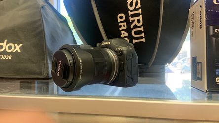 Canon R7 with 18-150mm lens.  Open box