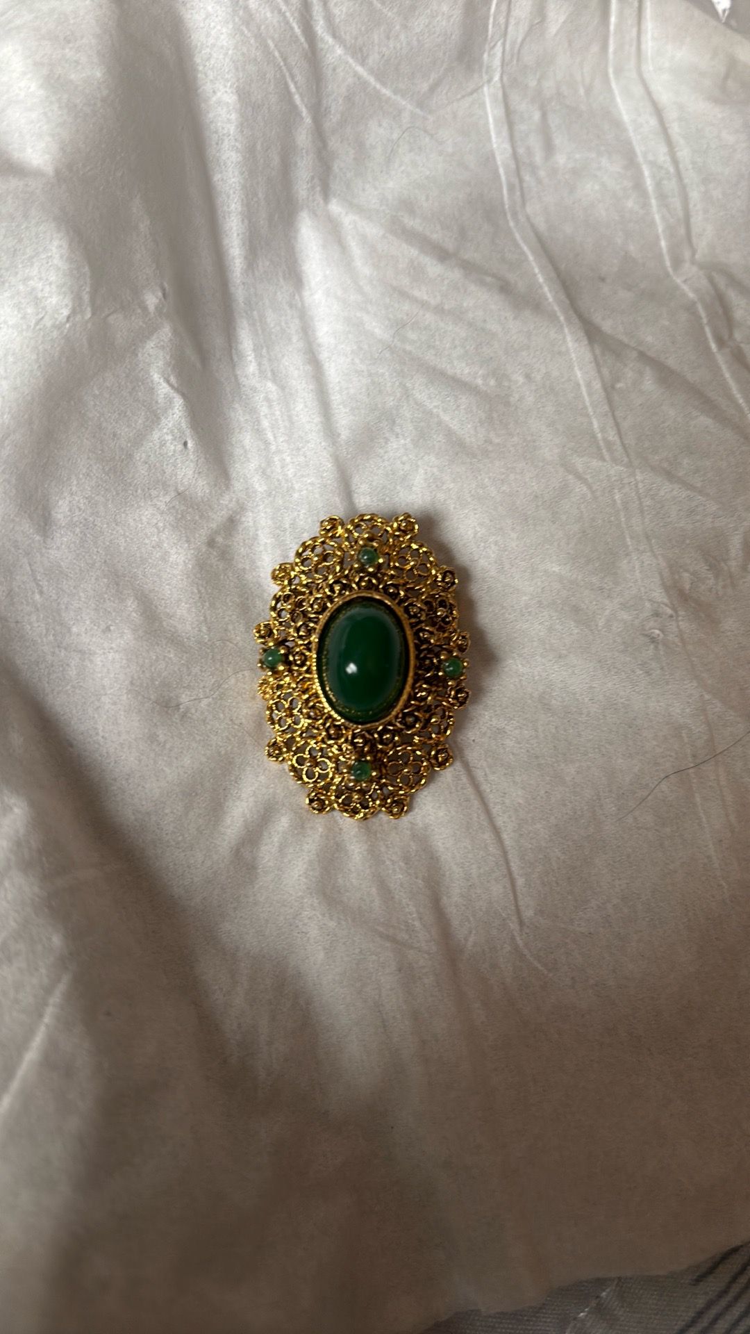 vintage Victorian-style gold-tone filigree costume brooch.