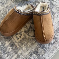 Fuzzy Slippers in a brown suede color.
