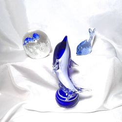 Glass dolphins. Cobalt blue and clear Dolphin figurines/paperweights. please see pics of slight chip