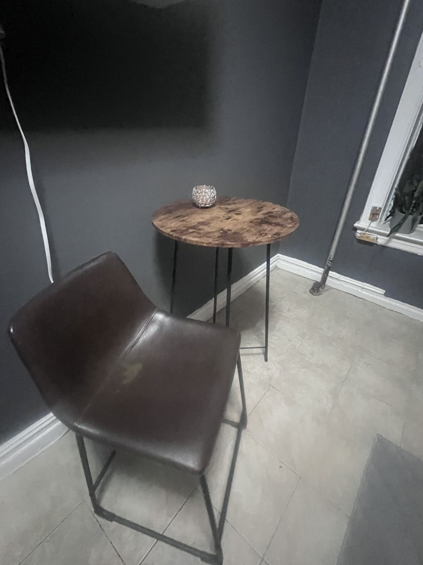 Bistro table and two brown chairs