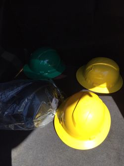 New Hard hats, yellow, green,and black