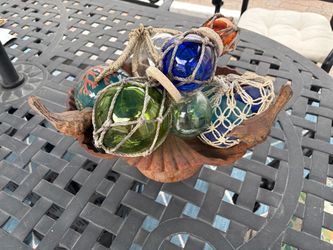 Cast iron bird shell bowl with glass floats weathered glass