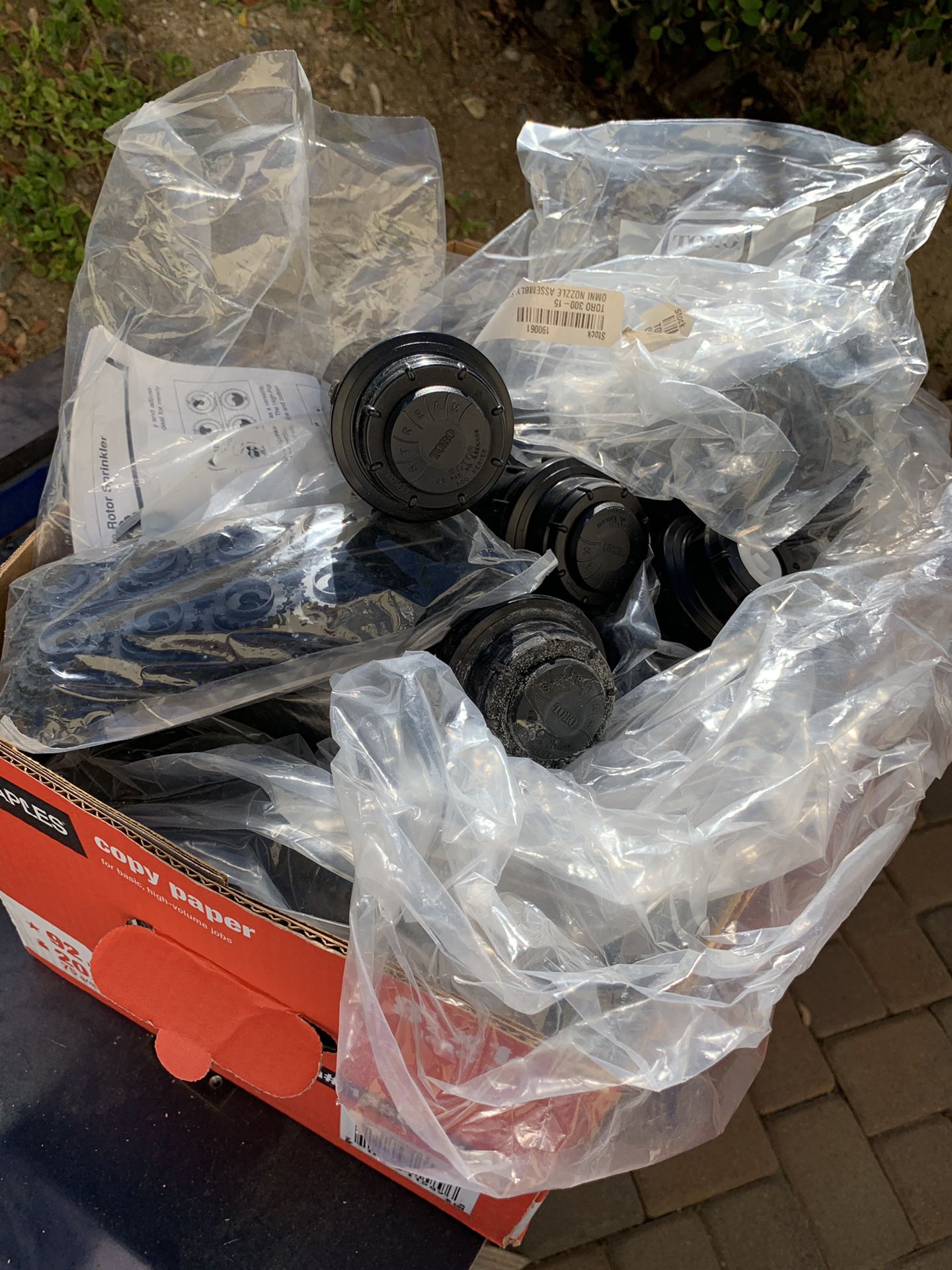 A huge box of toro pop up sprinkler heads and nozzle