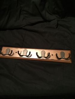 Wooden hanger with pegs