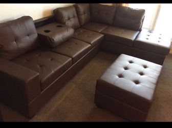 BROWN LEATHER SECTIONAL SOFA WITH CUPHOLDERS AND STORAGE OTTOMAN NEW