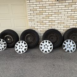 4 Honda tires with rims and covers size 235/65 R 16