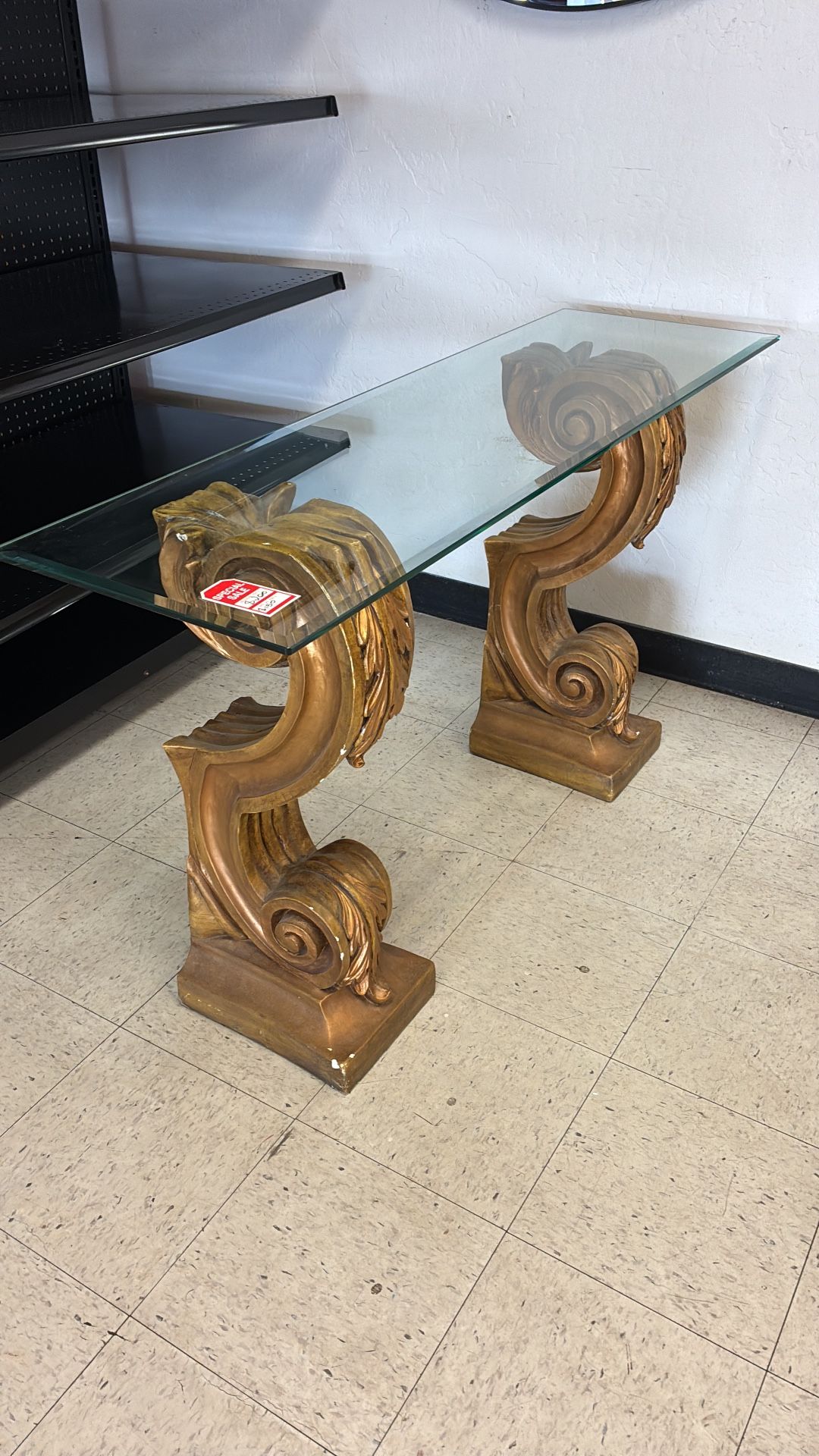 Elegant Glass Console Table with Ornate Gold Scroll Base