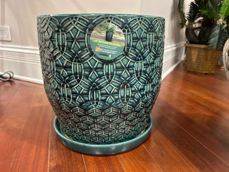 a 12-inch glazed ceramic planter with a matching attached saucer
