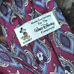 This is a vintage Walt Disney Company Mickey Mouse red silk necktie with a novelty print. 