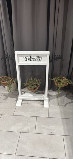 Welcome  sign with plants hangers