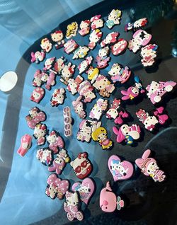54 Hello kitty croc charms all for $20