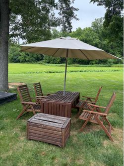 Outdoor dining table with chairs and umbrella