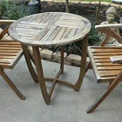 Round wooden table with two matching chairs
