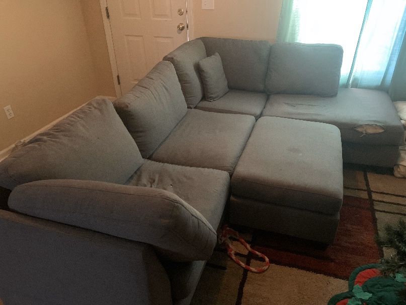 Grey sectional couch with ottoman