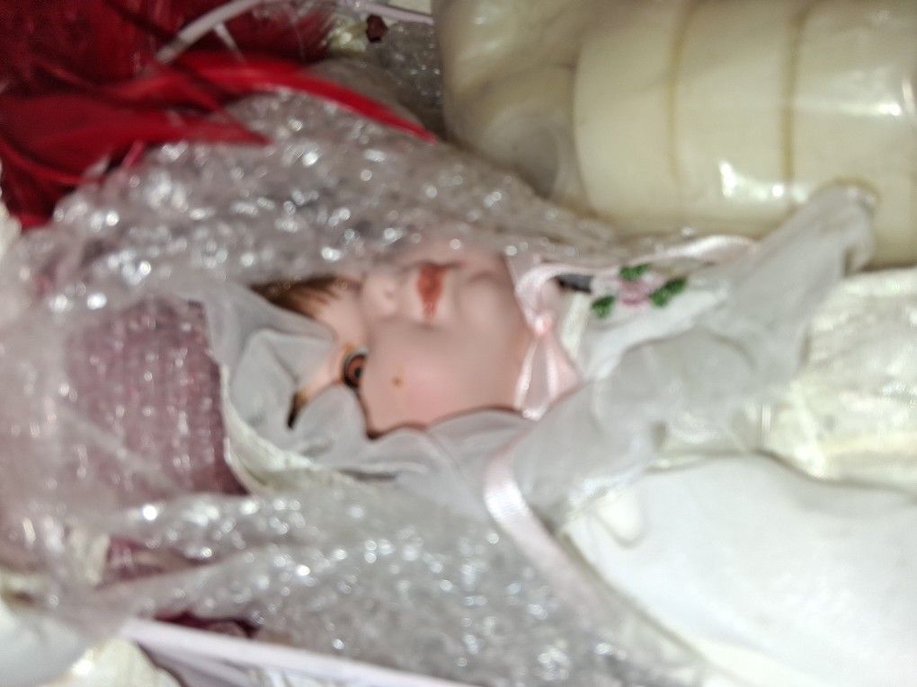 Beautiful BABY PORCELAIN DOLL. IN A ANTIQUE CANOPY BED .
