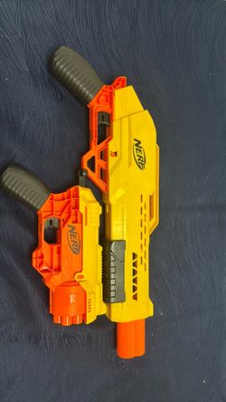 The NERF Alpha Strike Wolf LR-1 the larger yellow/orange blaster and The NERF Alpha Strike Cobra RC-6 the smaller yellow/orange blaster